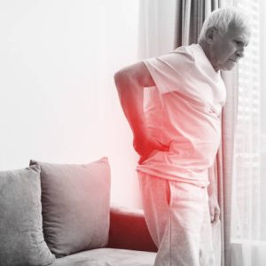 Senior man is suffering from pain in lower back at home